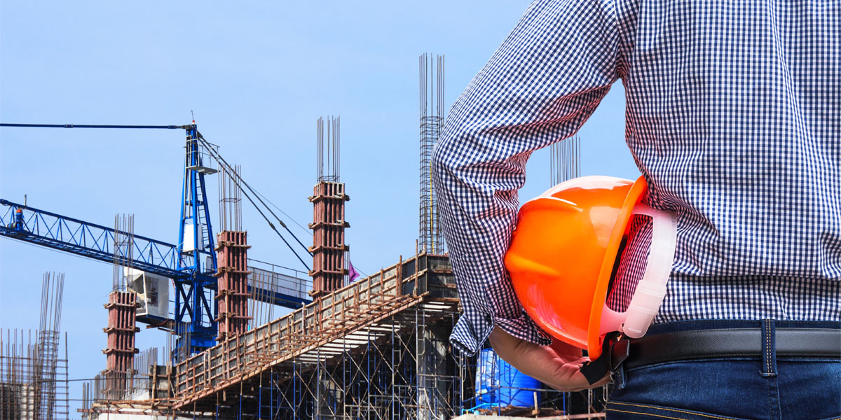 engineer holding yellow safety helmet in building construction s